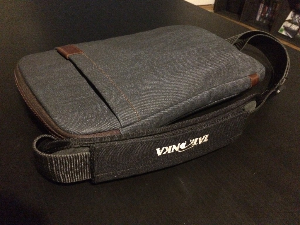 Closed MacBook holster with iPad, MacBook, power supply, adapter & 3G dongle inside.